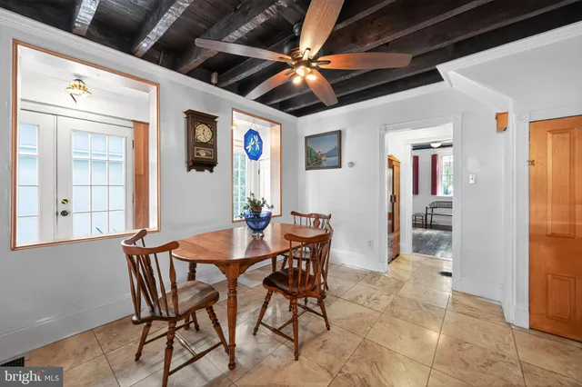 a view of a dining room with furniture and a chandelier