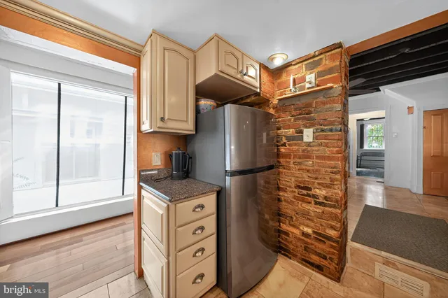 a kitchen with stainless steel appliances granite countertop a refrigerator and a stove