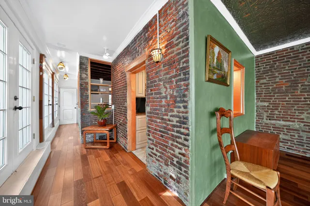 a view of a livingroom with furniture window and wooden floor