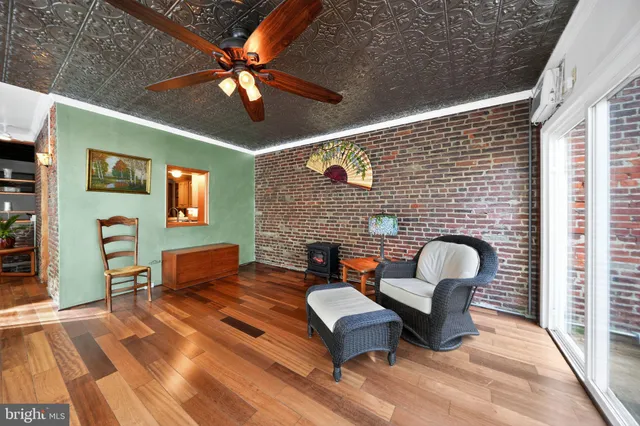 a living room with furniture a fireplace and wooden floor
