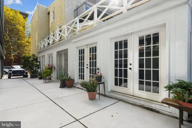 a building with potted plant in front of door