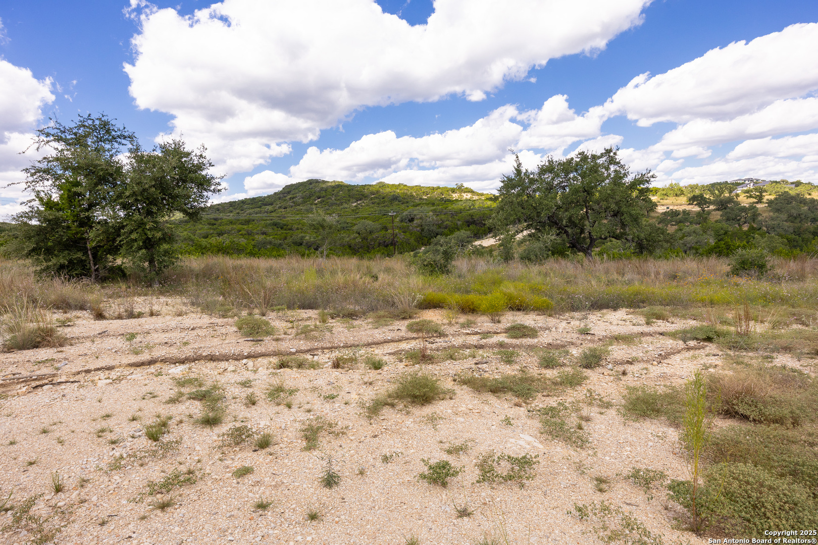 11309 Sloanes Ridge San Antonio, TX 78255 - Photo 18 of 19 a view of a lake with a yard