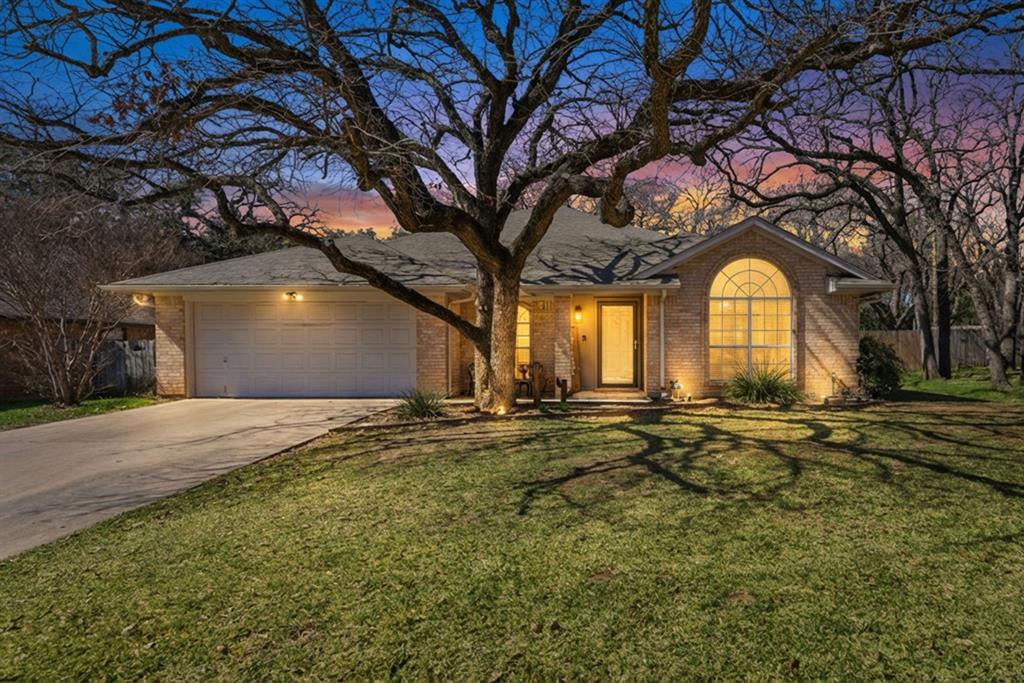 a view of a house with lots of trees and plants