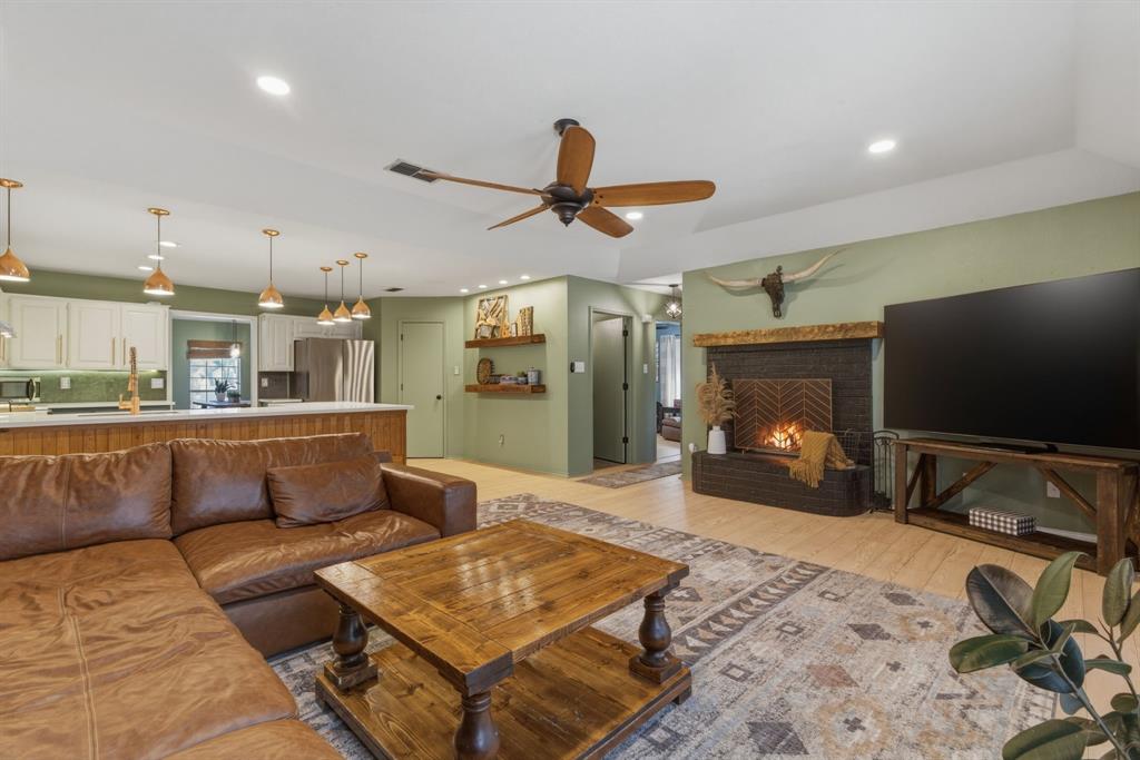 945 Lakeridge Drive Azle, TX 76020 - Photo 11 of 40 a living room with furniture and a flat screen tv