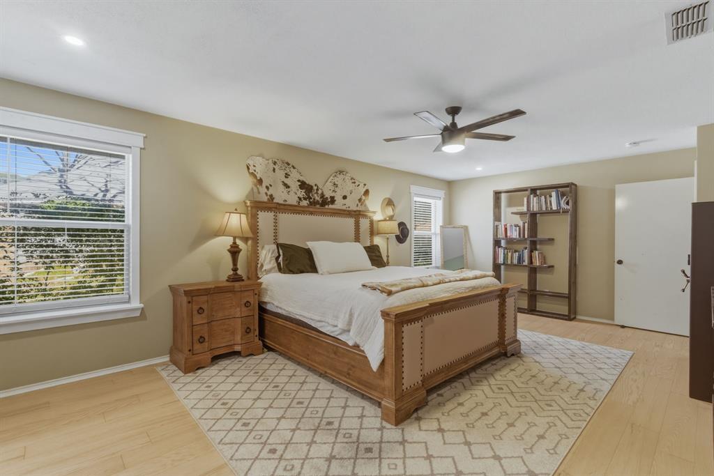 945 Lakeridge Drive Azle, TX 76020 - Photo 19 of 40 a bed sitting in a spacious bedroom next to a window