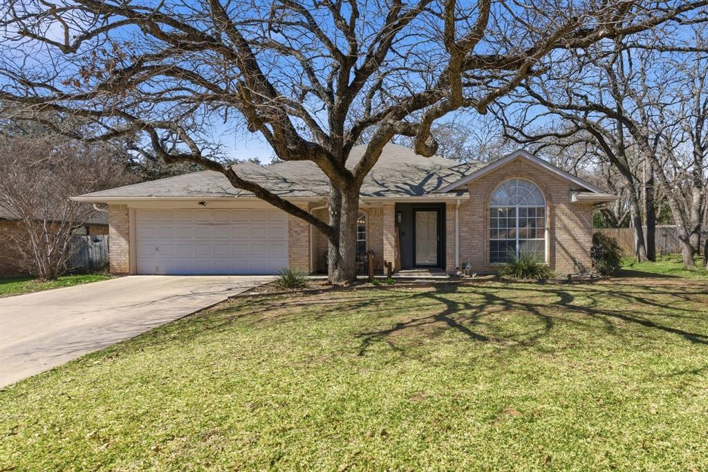 945 Lakeridge Drive Azle, TX 76020 - Photo 2 of 40 a front view of a house with a garden