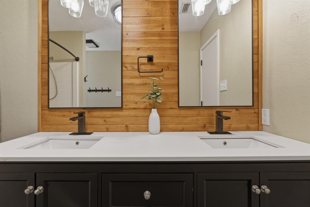 945 Lakeridge Drive Azle, TX 76020 - Photo 21 of 40 a bathroom with a sink and a mirror
