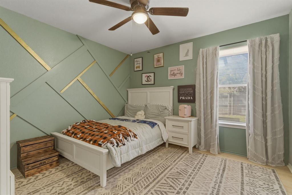 945 Lakeridge Drive Azle, TX 76020 - Photo 23 of 40 a bedroom with a bed and a window