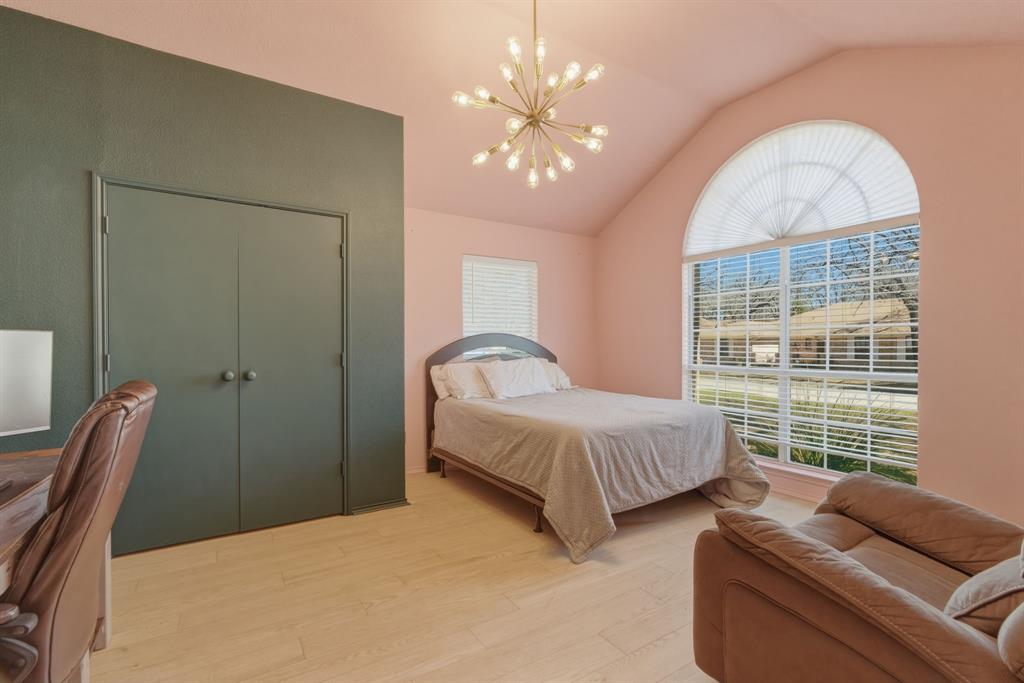 945 Lakeridge Drive Azle, TX 76020 - Photo 24 of 40 a spacious bedroom with bed and a large window