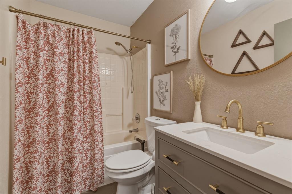 945 Lakeridge Drive Azle, TX 76020 - Photo 26 of 40 a bathroom with a sink toilet and shower