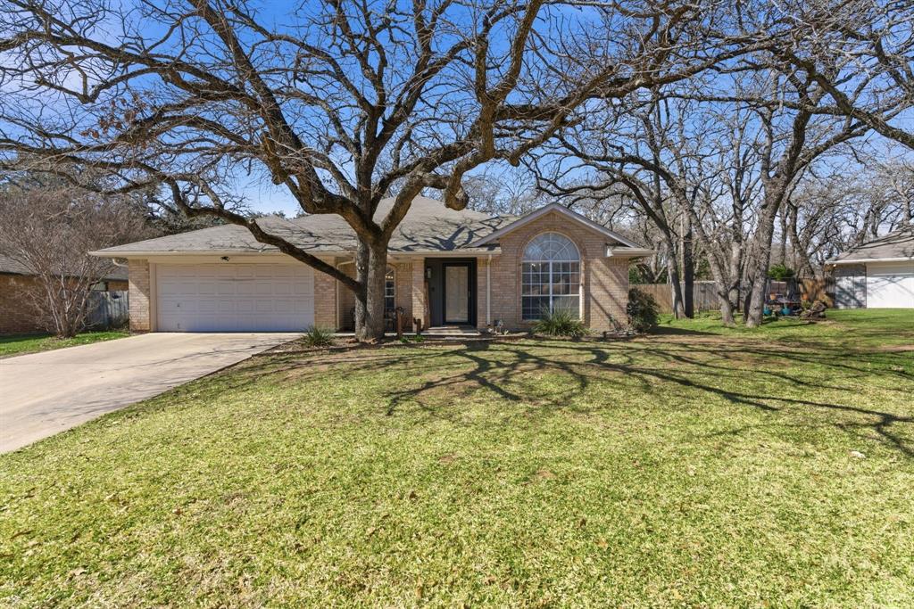 945 Lakeridge Drive Azle, TX 76020 - Photo 3 of 40 a front view of a house with a yard