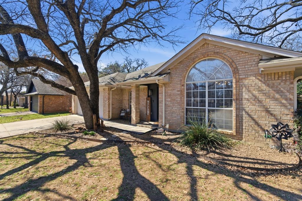 945 Lakeridge Drive Azle, TX 76020 - Photo 4 of 40 a front view of a house with a yard