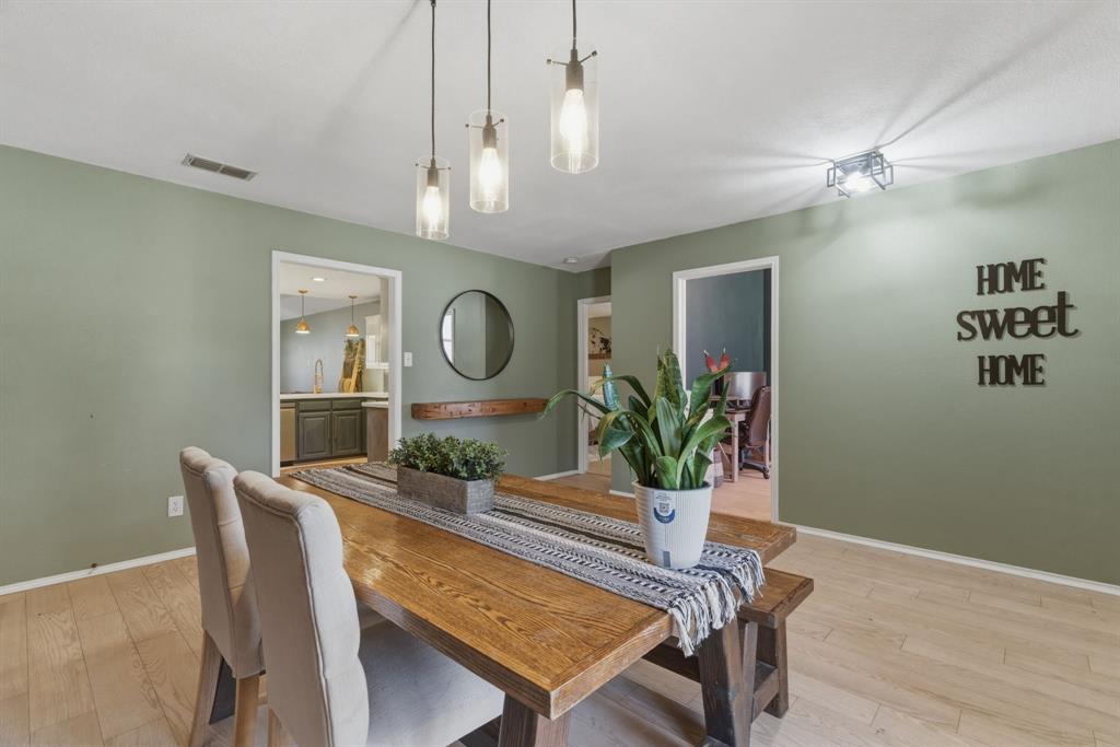 945 Lakeridge Drive Azle, TX 76020 - Photo 8 of 40 a view of a dining room with furniture and a chandelier