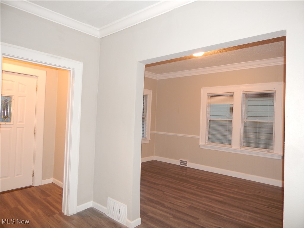 3845 Summit Park Road Cleveland Heights, OH 44121 - Photo 6 of 15 View of foyer and dining room, crown molding, baseboards, and wood finished floors