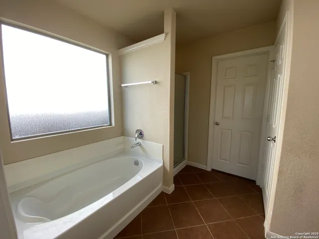 a bathroom with a bathtub and a shower