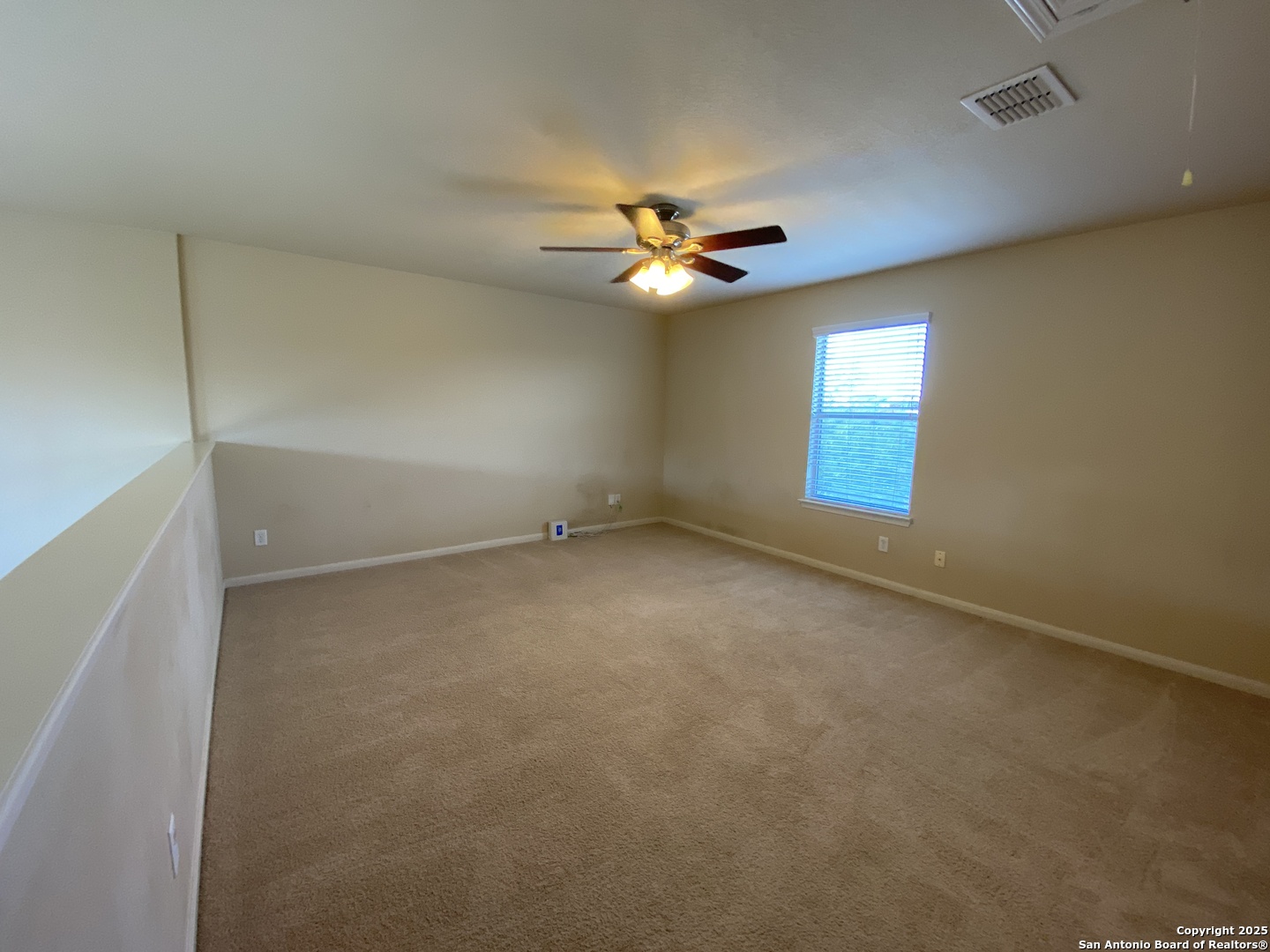10714 Ranchland Fox San Antonio, TX 78245 - Photo 18 of 24 an empty room with a window and a fan