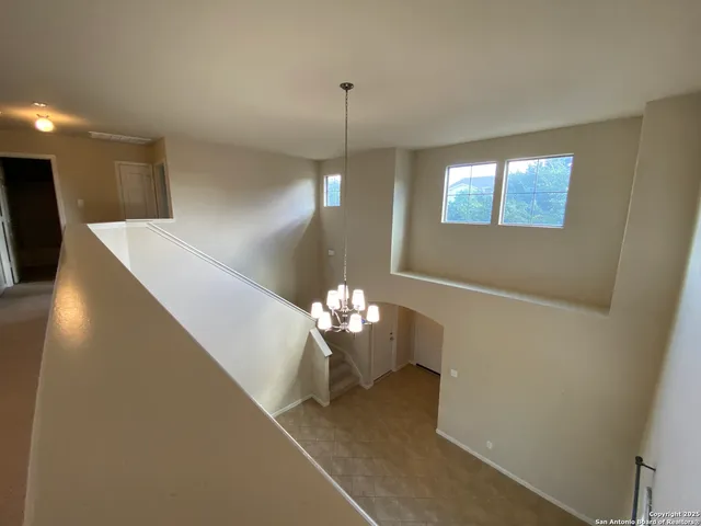 a lobby with furniture and chandelier