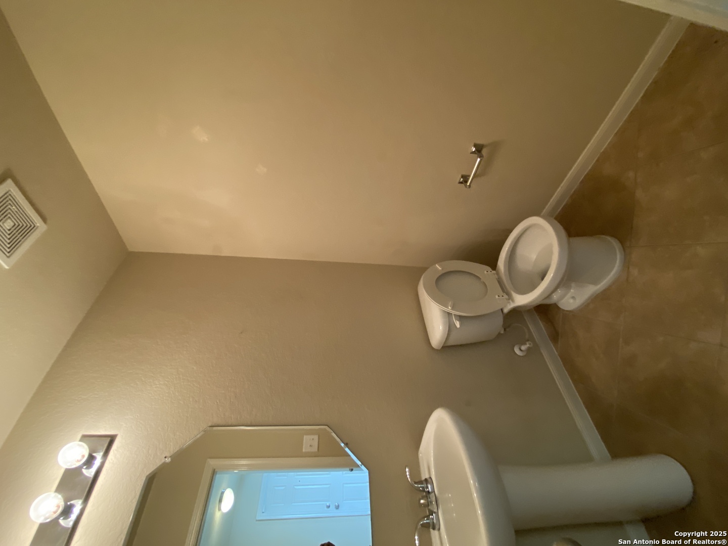 10714 Ranchland Fox San Antonio, TX 78245 - Photo 7 of 24 a bathroom with a toilet