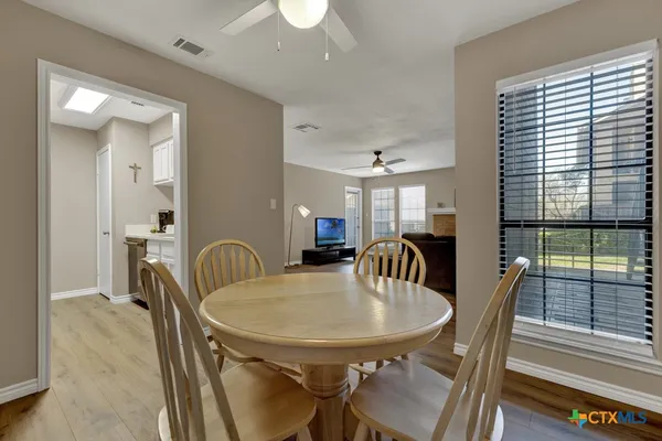 a dining room with furniture and window