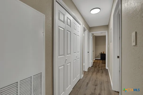 a view of a hallway with a livingroom with a hallway
