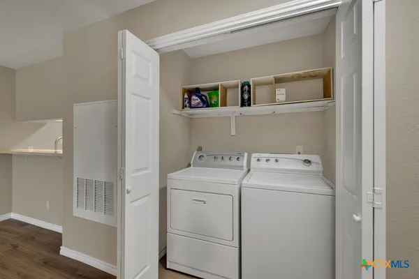 a view of storage and utility room with washer and dryer