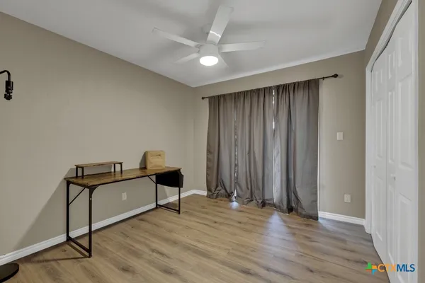 a view of a room with wooden floor