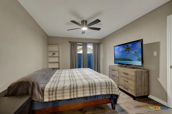 a bedroom with a bed and a flat screen tv