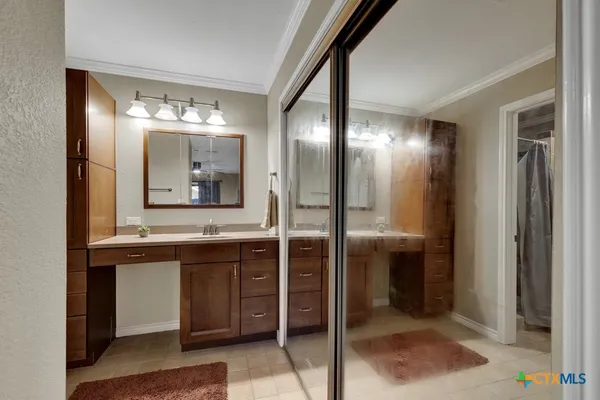 a bathroom with a double vanity sink and a mirror