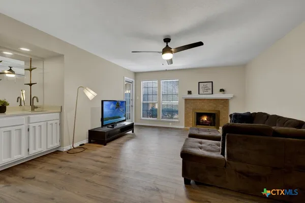 a living room with furniture and a fireplace