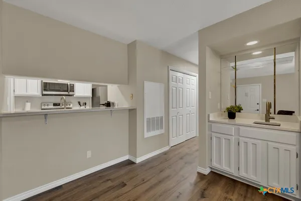 a kitchen with stainless steel appliances a refrigerator sink and microwave