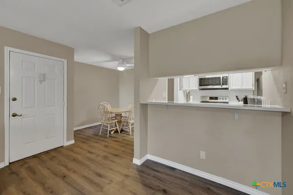 a kitchen with stainless steel appliances a refrigerator and a stove top oven