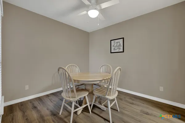 a view of a dining room with furniture and wooden floor