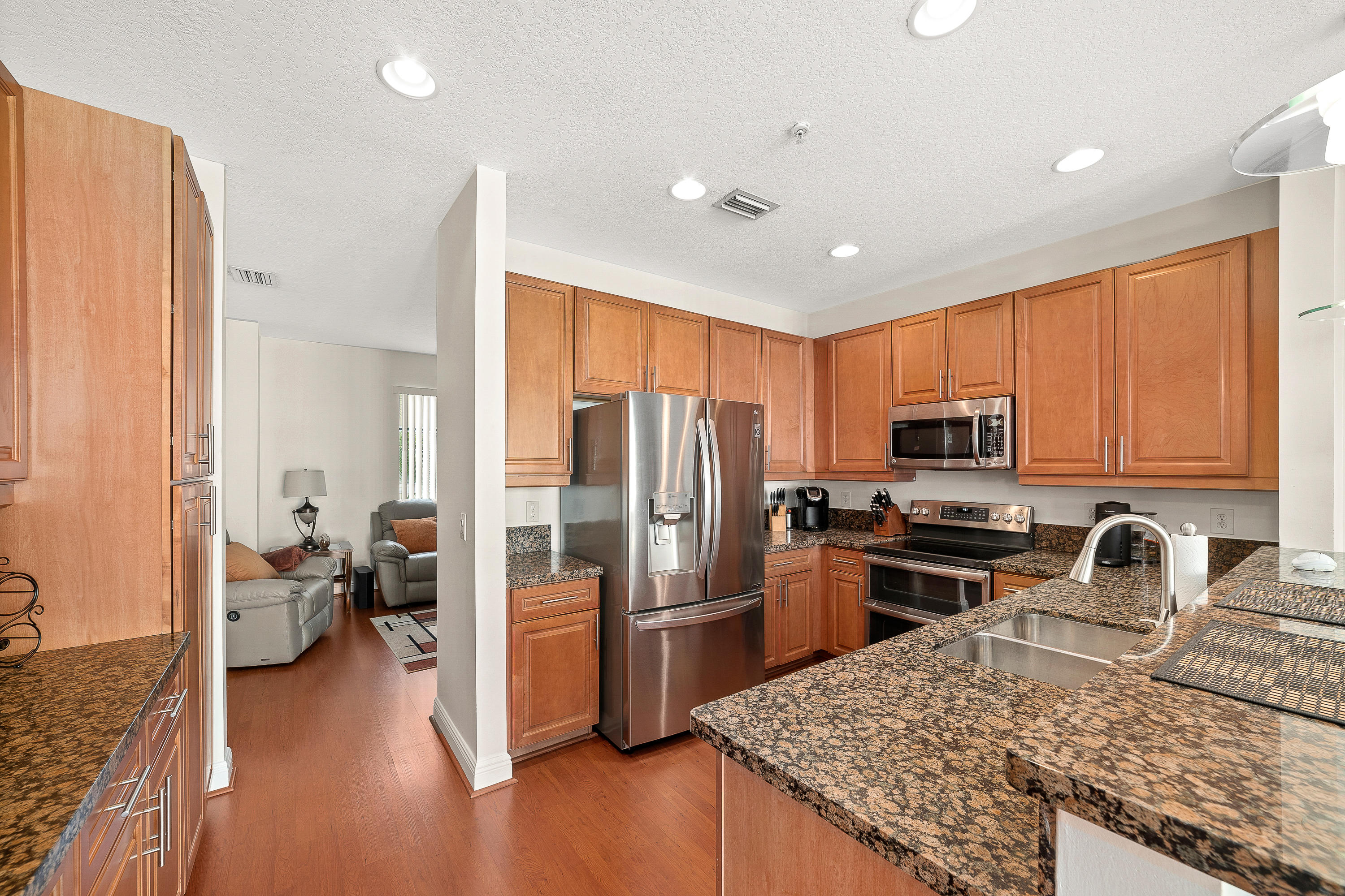 613 Northwest 38th Circle Boca Raton, FL 33431 - Photo 12 of 31 a kitchen with granite countertop a refrigerator stove and sink