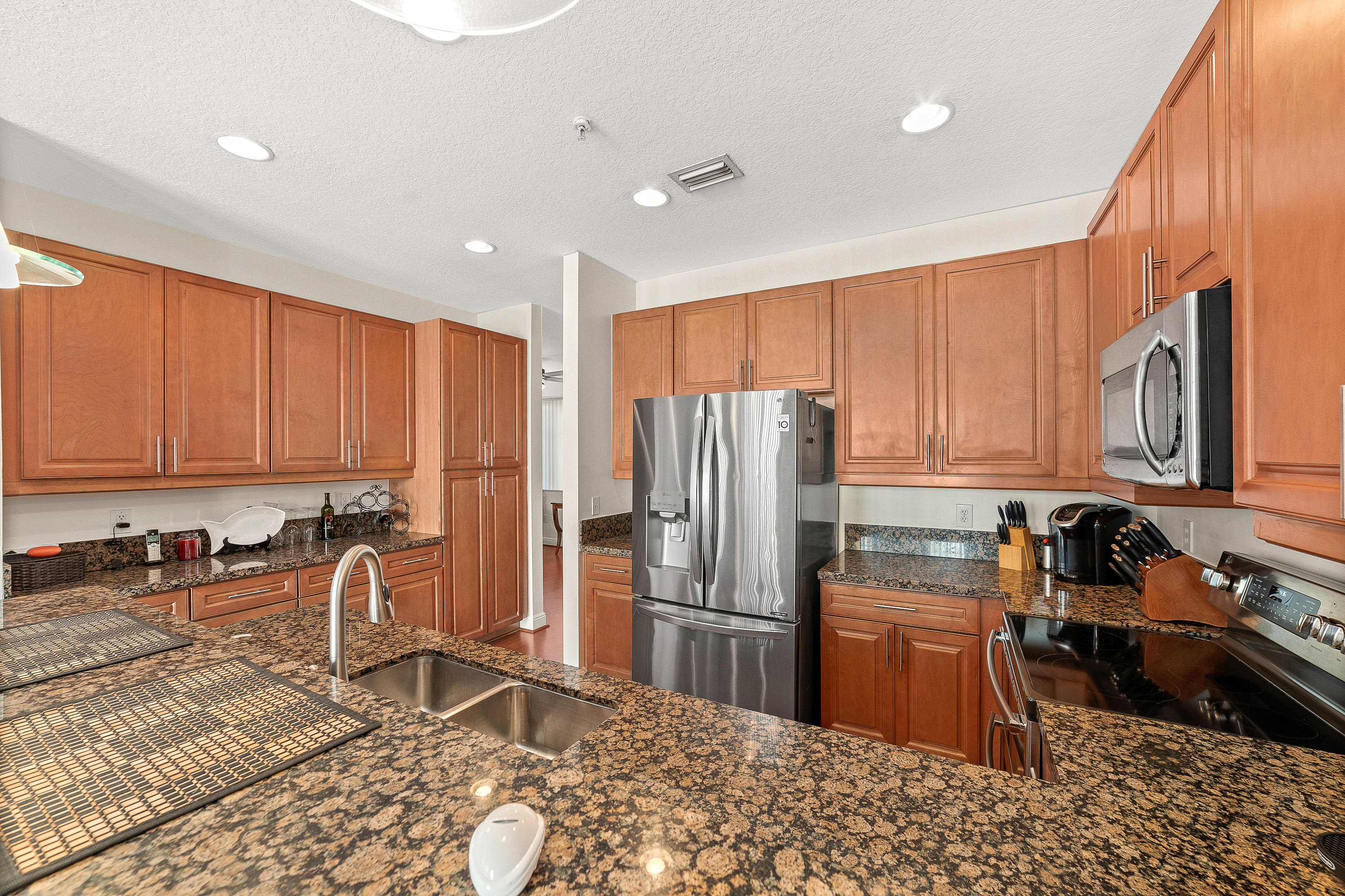 613 Northwest 38th Circle Boca Raton, FL 33431 - Photo 13 of 31 a kitchen with stainless steel appliances granite countertop a refrigerator stove top oven and sink