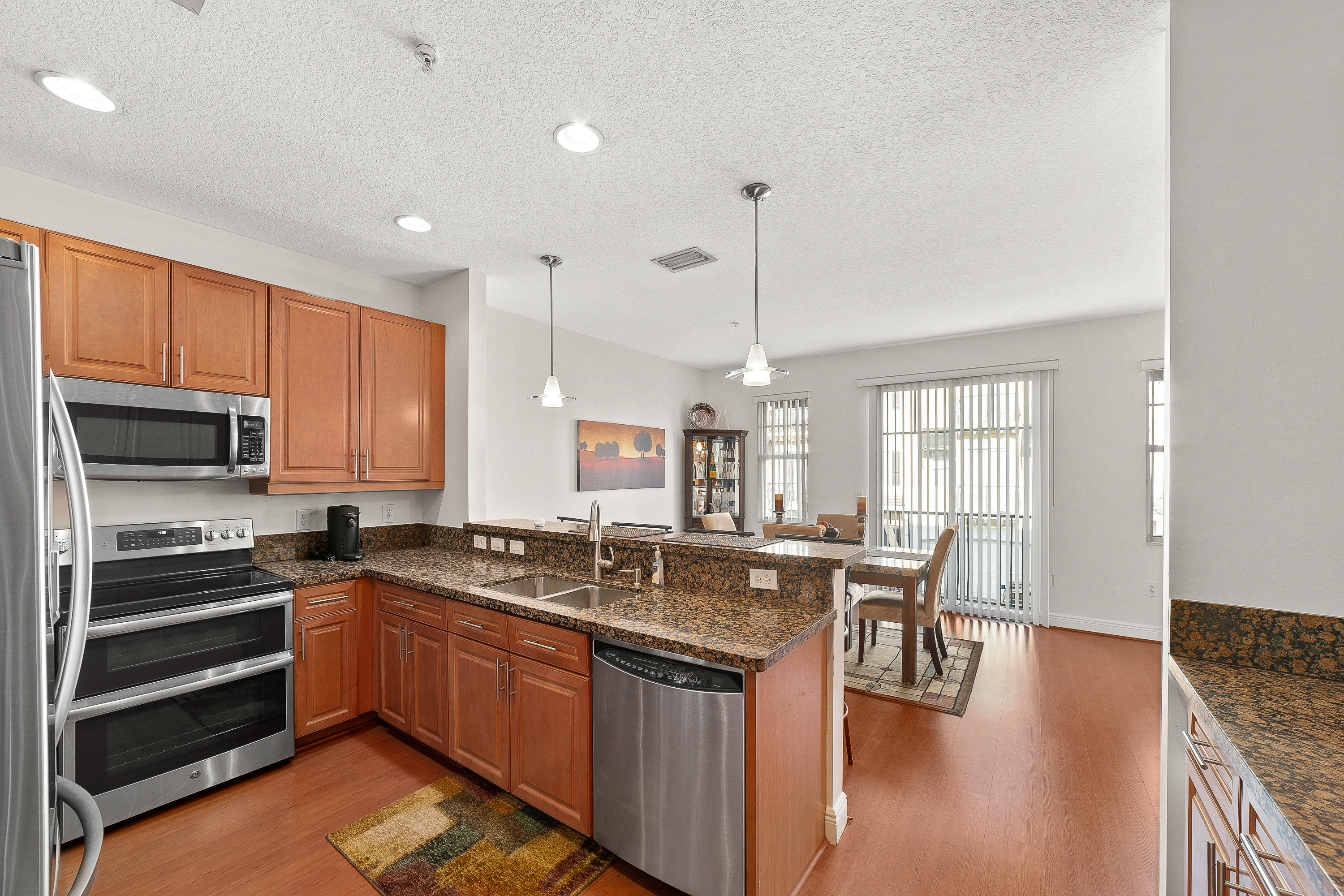 613 Northwest 38th Circle Boca Raton, FL 33431 - Photo 14 of 31 a kitchen with a sink stove and cabinets