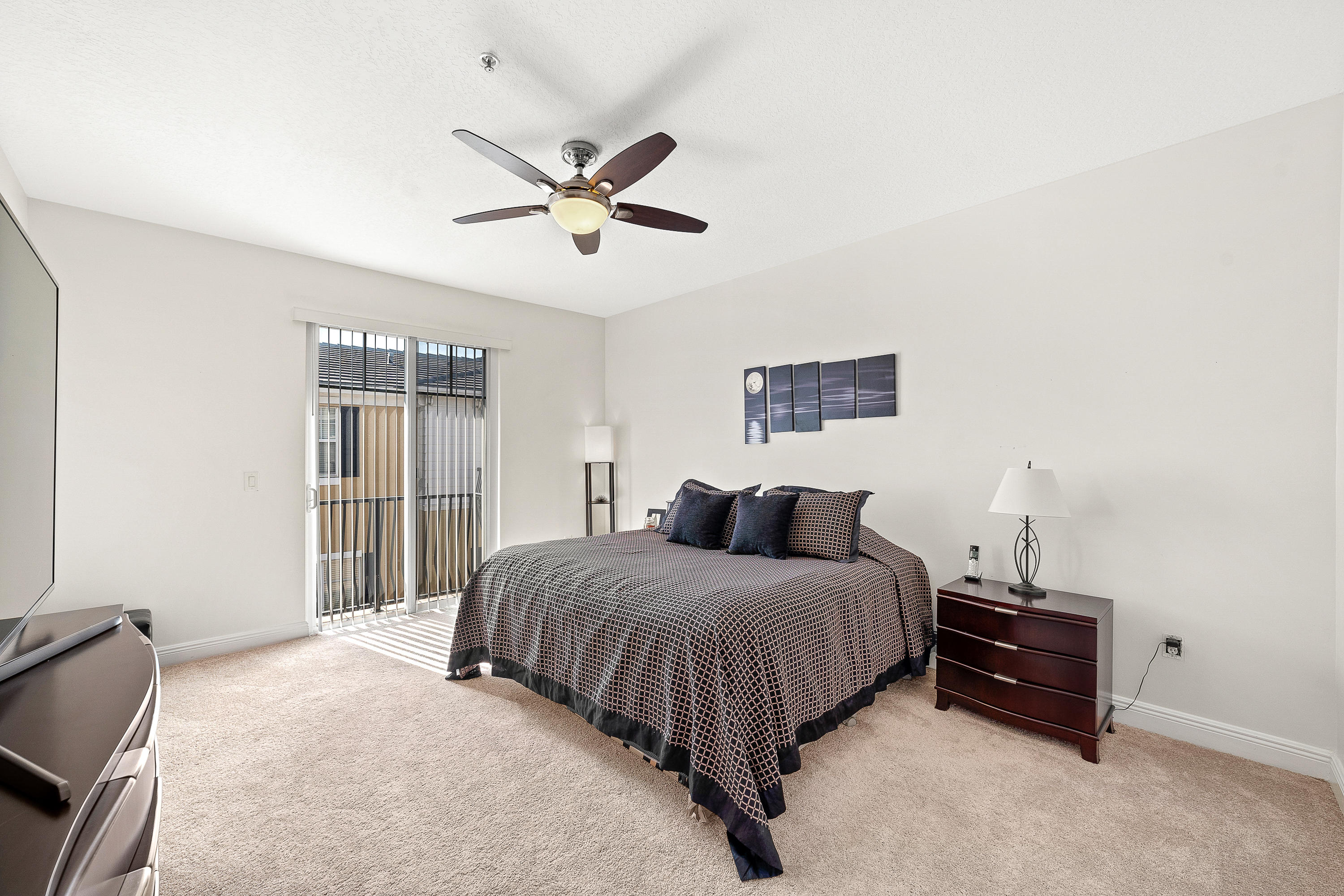 613 Northwest 38th Circle Boca Raton, FL 33431 - Photo 19 of 31 a bedroom with a bed and a chandelier