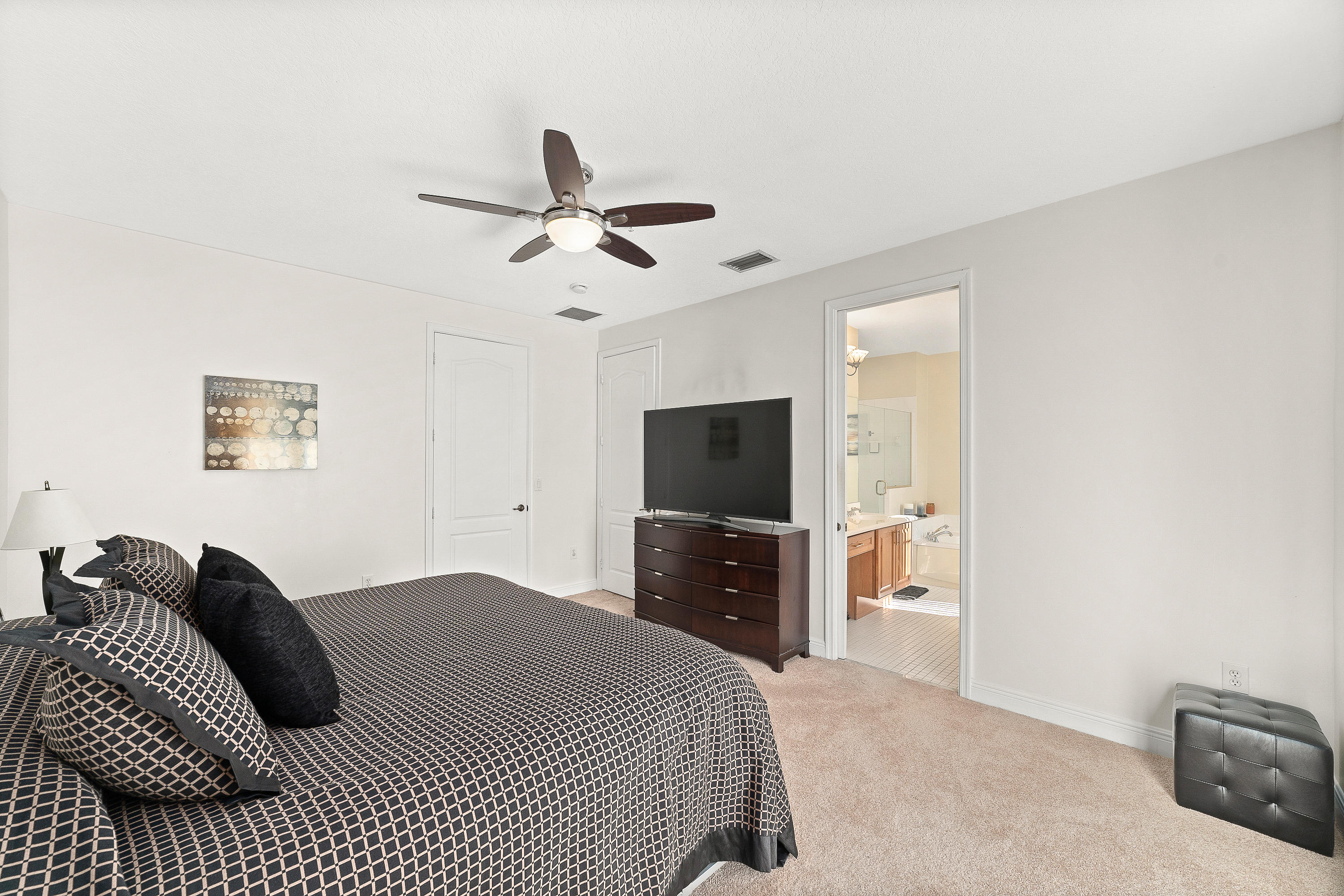 613 Northwest 38th Circle Boca Raton, FL 33431 - Photo 20 of 31 a bedroom with a bed and a flat screen tv
