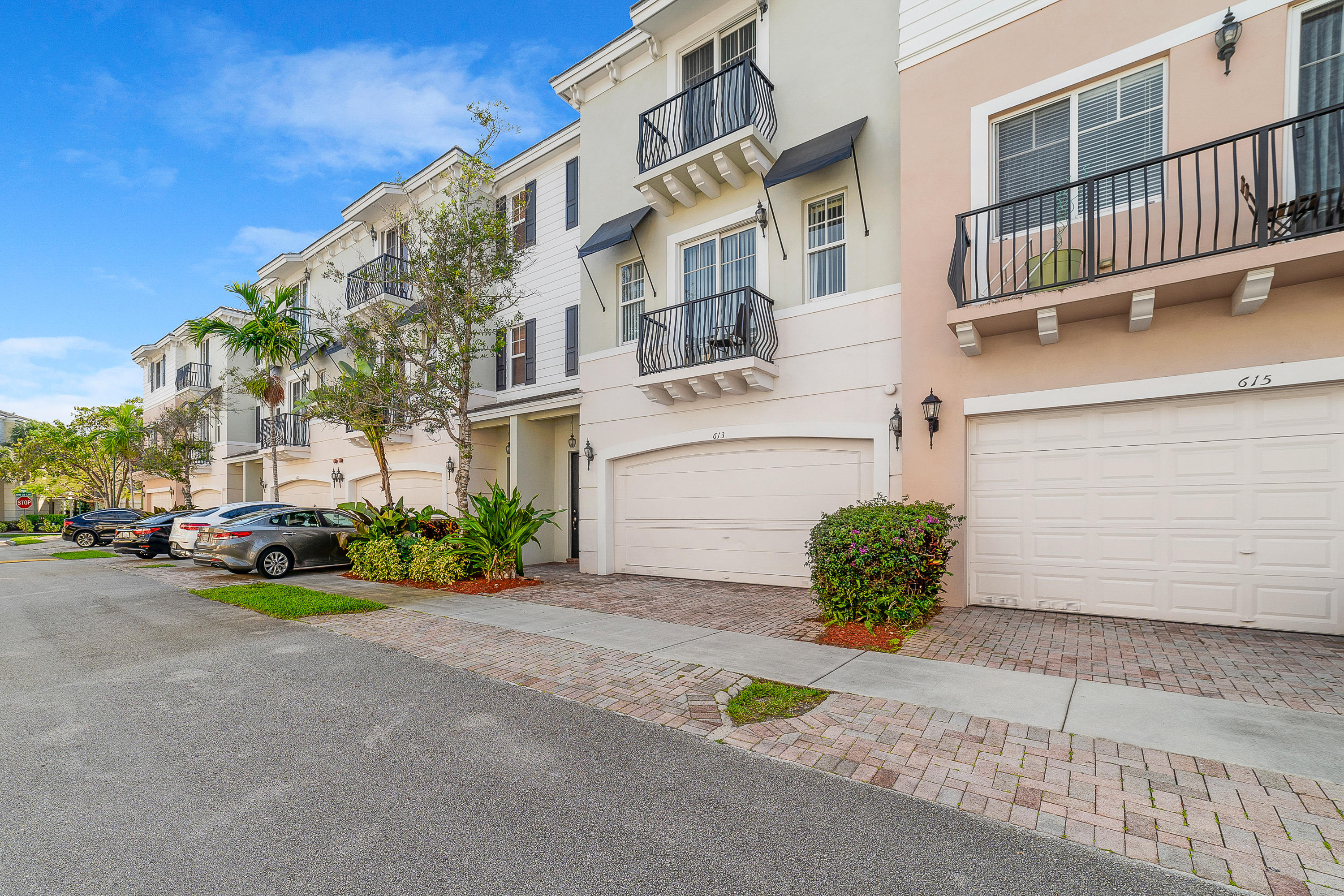 613 Northwest 38th Circle Boca Raton, FL 33431 - Photo 2 of 31 a front view of a building with garden and parking