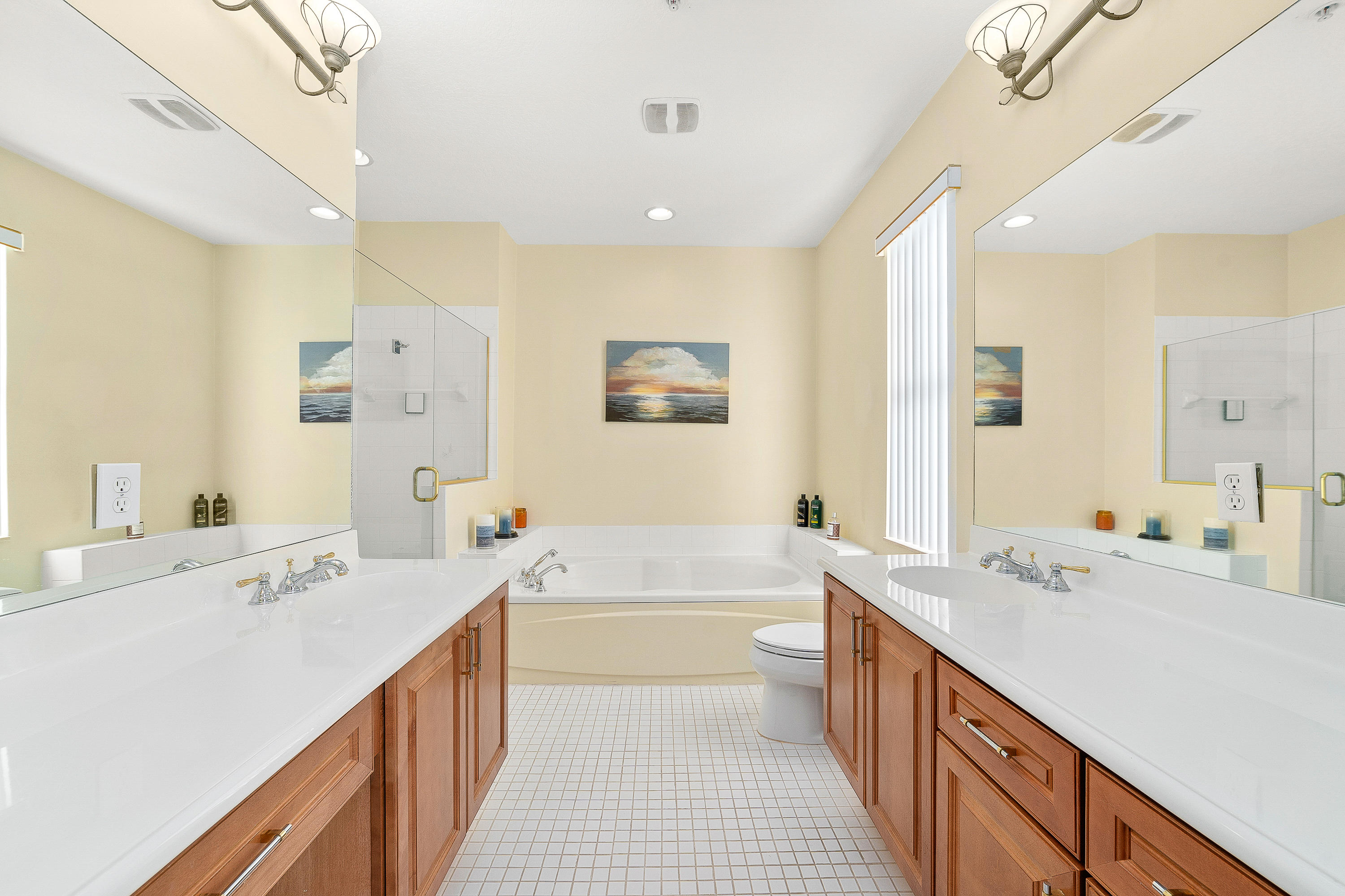 613 Northwest 38th Circle Boca Raton, FL 33431 - Photo 21 of 31 a bathroom with a double vanity sink a large mirror and a bathtub