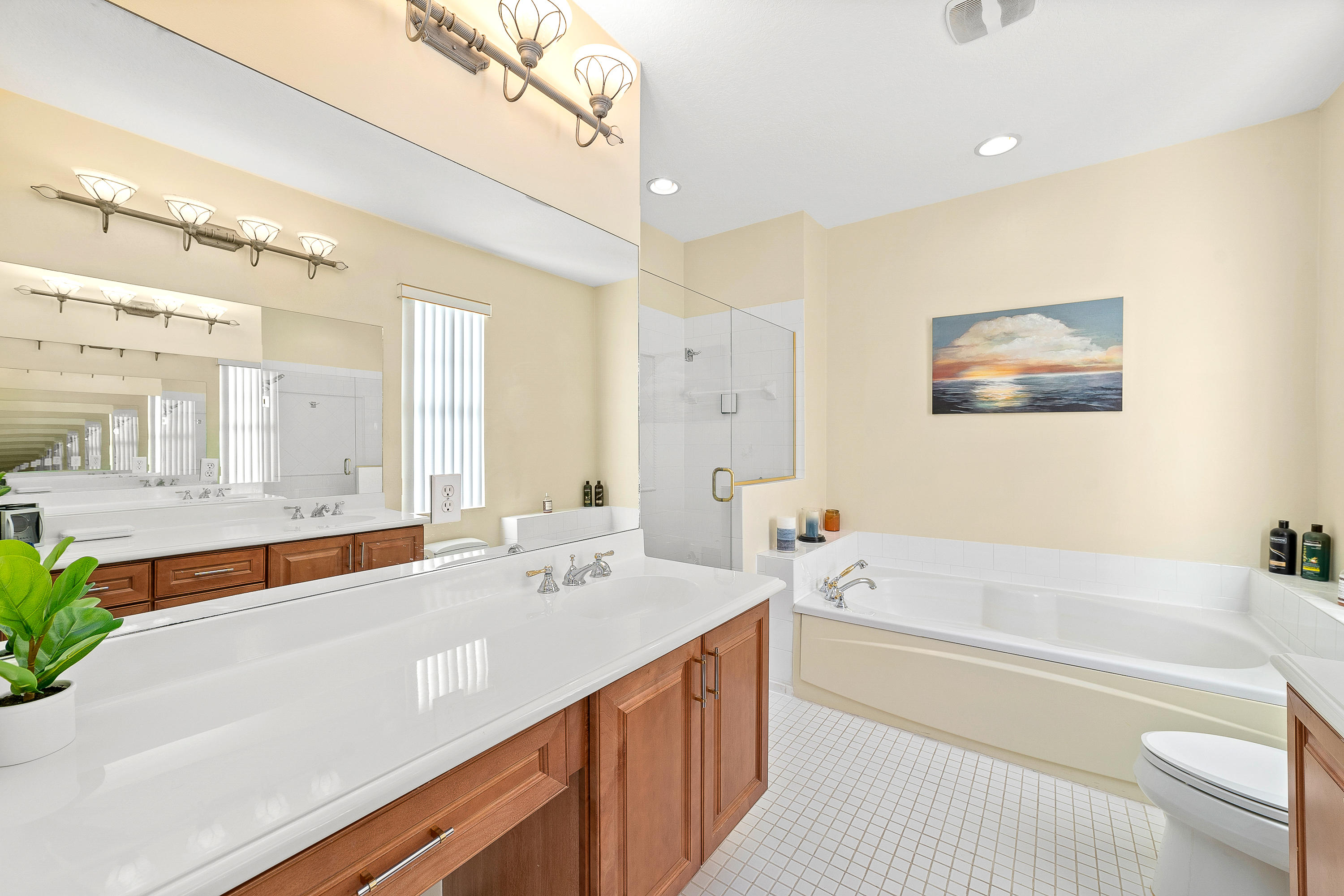 613 Northwest 38th Circle Boca Raton, FL 33431 - Photo 22 of 31 a spacious bathroom with a double vanity sink a mirror and a bathtub