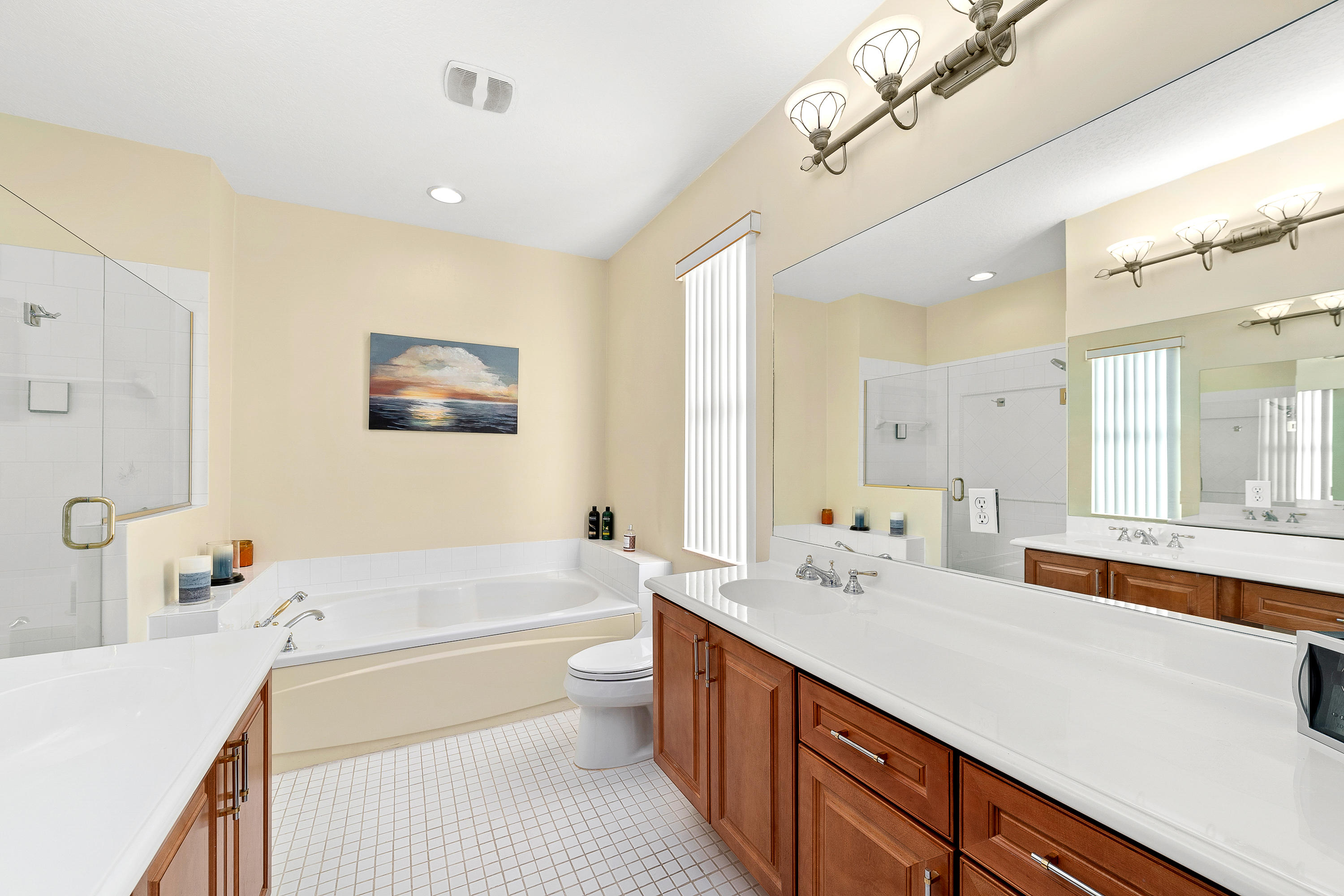 613 Northwest 38th Circle Boca Raton, FL 33431 - Photo 23 of 31 a bathroom with a double vanity sink a large mirror and a bathtub