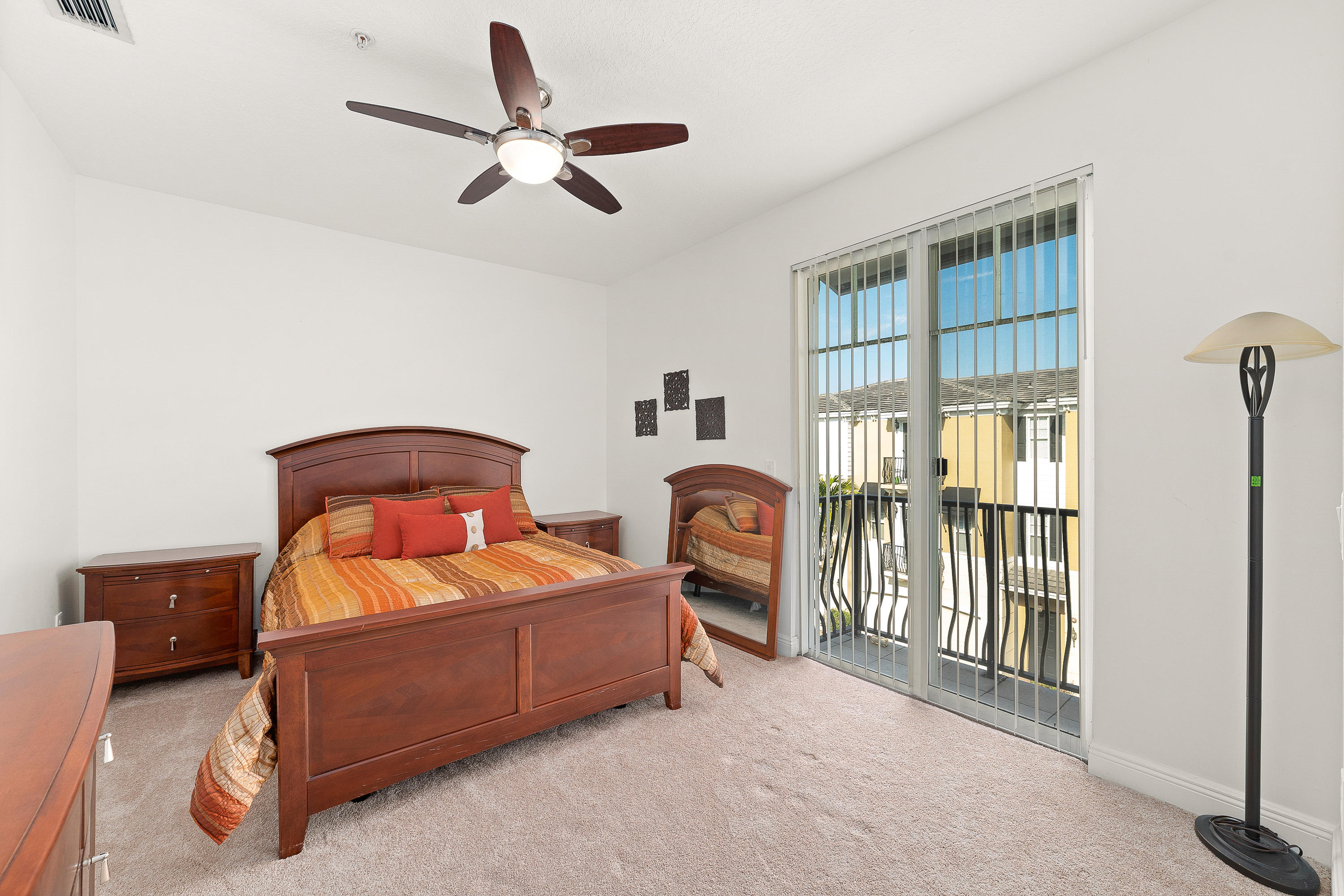 613 Northwest 38th Circle Boca Raton, FL 33431 - Photo 30 of 31 a bedroom with a bed and a large ceiling fan