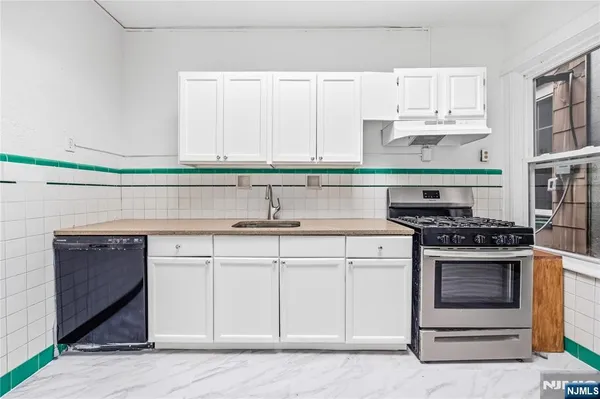 a kitchen with cabinets appliances and a sink