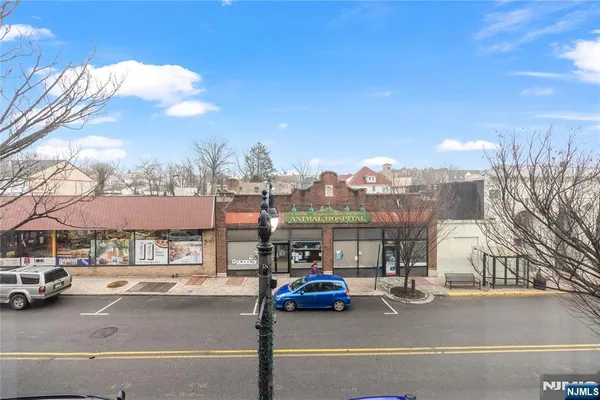 a view of city street with a parked cars road