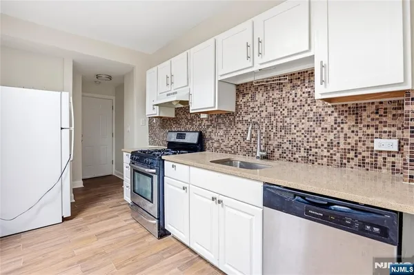 a kitchen with a sink and cabinets