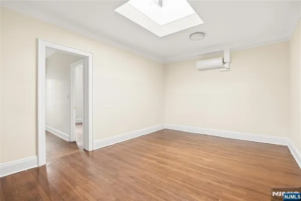 an empty room with wooden floor and closet