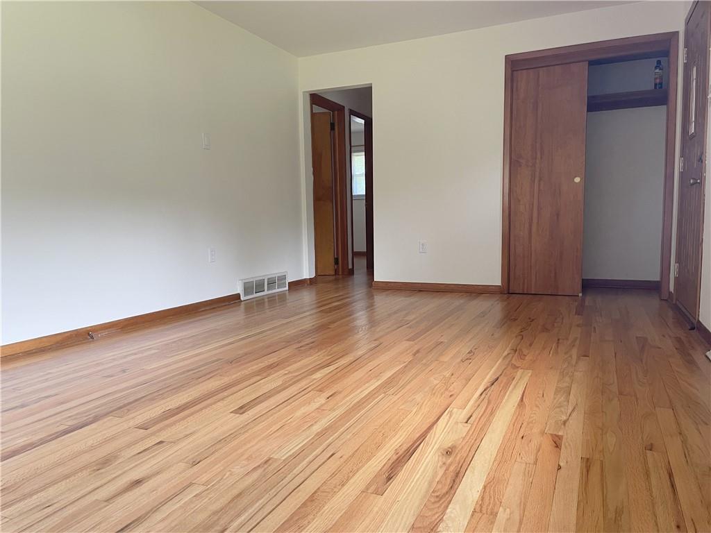 1658 Pulaski Road New Castle, PA 16105 - Photo 3 of 21 a view of an empty room with wooden floor and closet