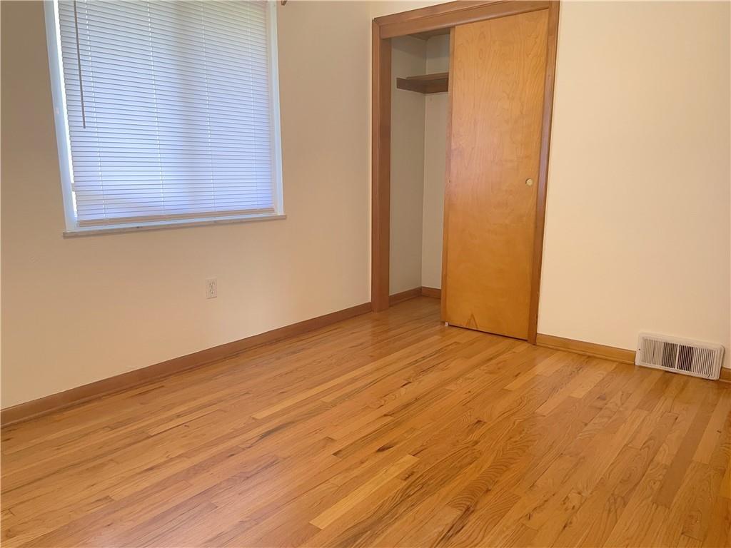 1658 Pulaski Road New Castle, PA 16105 - Photo 8 of 21 an empty room with wooden floor and windows