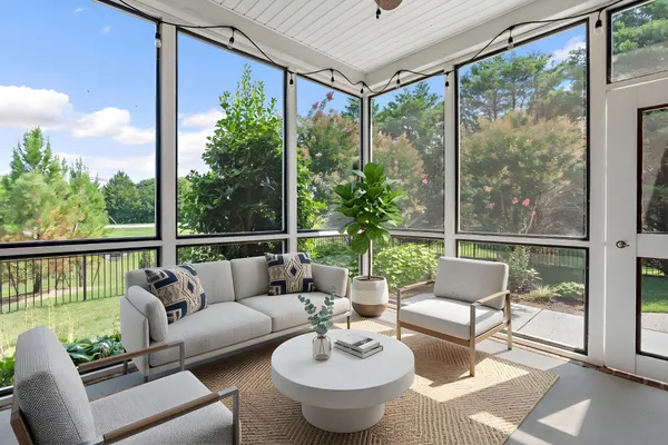 a balcony with furniture and garden view