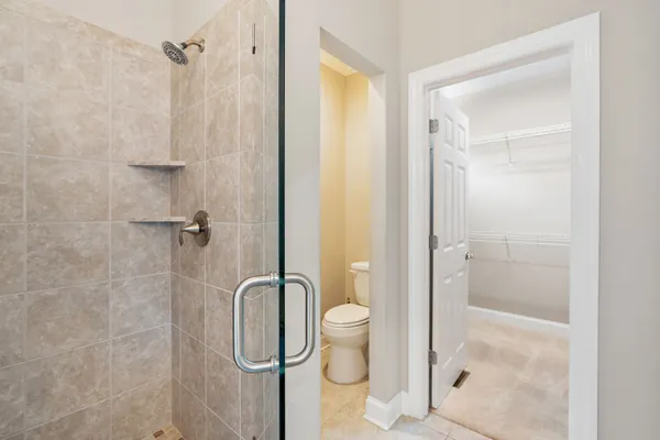 a bathroom with a shower and toilet